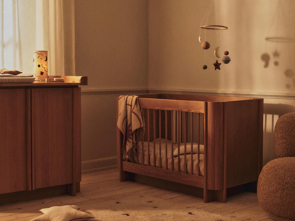 Skye Mobile von Ferm Living über dem Kinderbett im warm eingerichteten Kinderzimmer